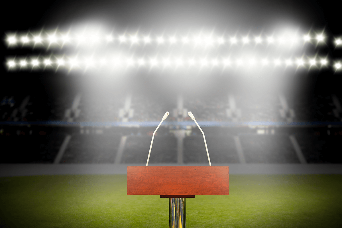 An empty podium and microphones at stadium with copy space.